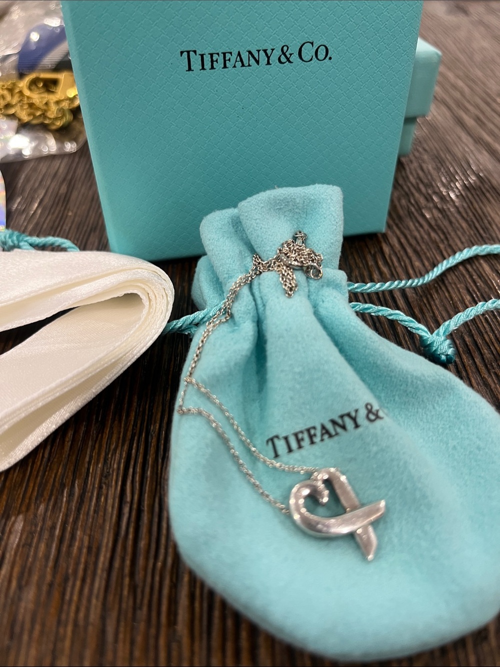 Tiffany & Co. Sterling Silver Ribbon Heart Pendant with pouch, box and ribbon